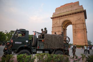 Military personnel with Indian Army stand guard at India Gate in New Delhi